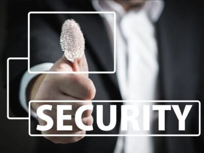 A man in a suit holding a finger with the word security on it.
