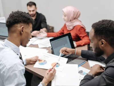 A group of business people sitting around a table.