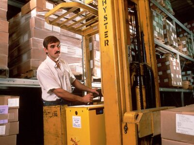 A yellow forklift in a warehouse.