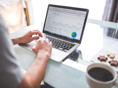 A man using a laptop with a graph on it.