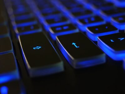 A close up of a keyboard with blue lights on it.