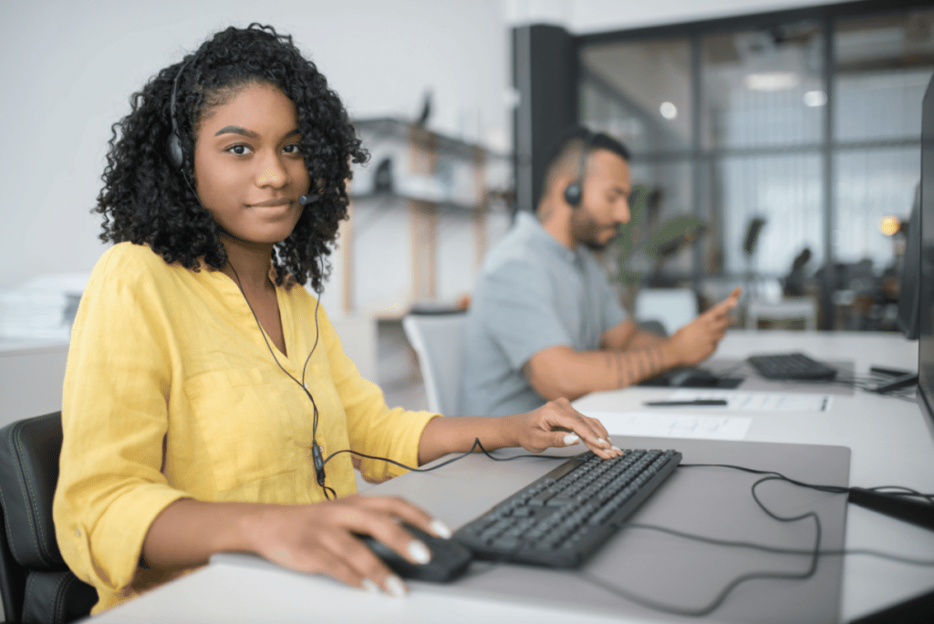 woman in yellow shirt providing IT support as part of a M365 managed services provider