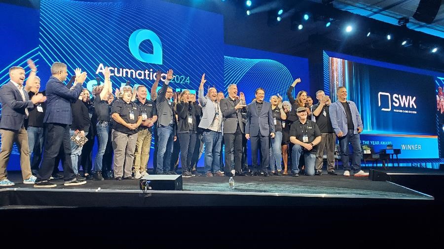 A picture of SWK executives and employees accepting the Acumatica Partner of the Year Award at Acumatica Summit 2024