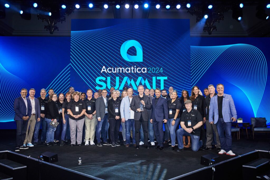 SWK Technologies' employees on stage at Acumatica Summit 2024 accepting the Partner of the Year award