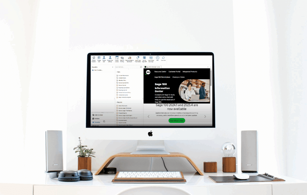 Computer monitor displaying Sage 100 ERP software interface with the Favorites navigation panel open on the left side, showing various folders and menu items, positioned on a clean white desk with minimal accessories.