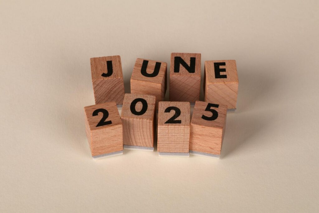 Wooden letter blocks arranged to spell "JUNE 2025" on a light background, representing the June 2025 cybersecurity news recap timeframe.