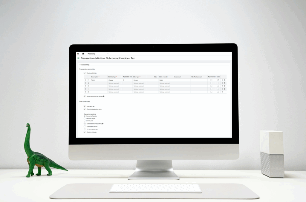 Computer monitor displaying Sage Intacct Transaction Definition configuration screen for Subcontract Invoice Tax setup, with a green toy dinosaur and white keyboard on a modern white desk.
