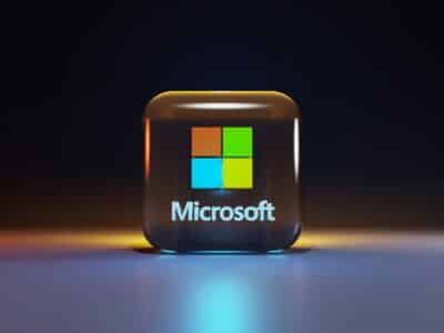 Microsoft 365 logo icon displayed on a dark background with glowing light effects, representing Microsoft 365 Business and Enterprise plan pricing changes effective July 2026.