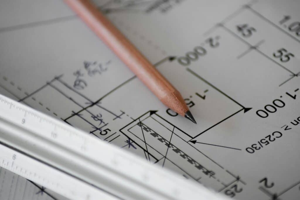 Commercial construction blueprint with pencil and ruler showing project plans and measurements