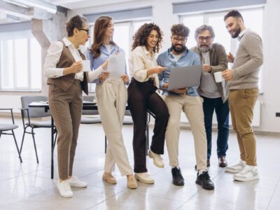Diverse finance professionals collaborating in modern office reviewing financial dashboards