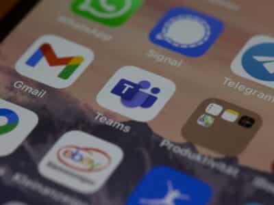 Close-up of a smartphone screen displaying a grid of app icons, with the Microsoft Teams icon centered and in focus, surrounded by Gmail, Signal, Telegram, eBay and other messaging and productivity apps.