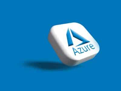 A 3D rendering of a white rounded square tile tilted at an angle, displaying the Microsoft Azure logo — a stylized blue letter "A" formed from three angled shapes above the word "Azure" in blue text — casting a soft shadow on a solid blue background.