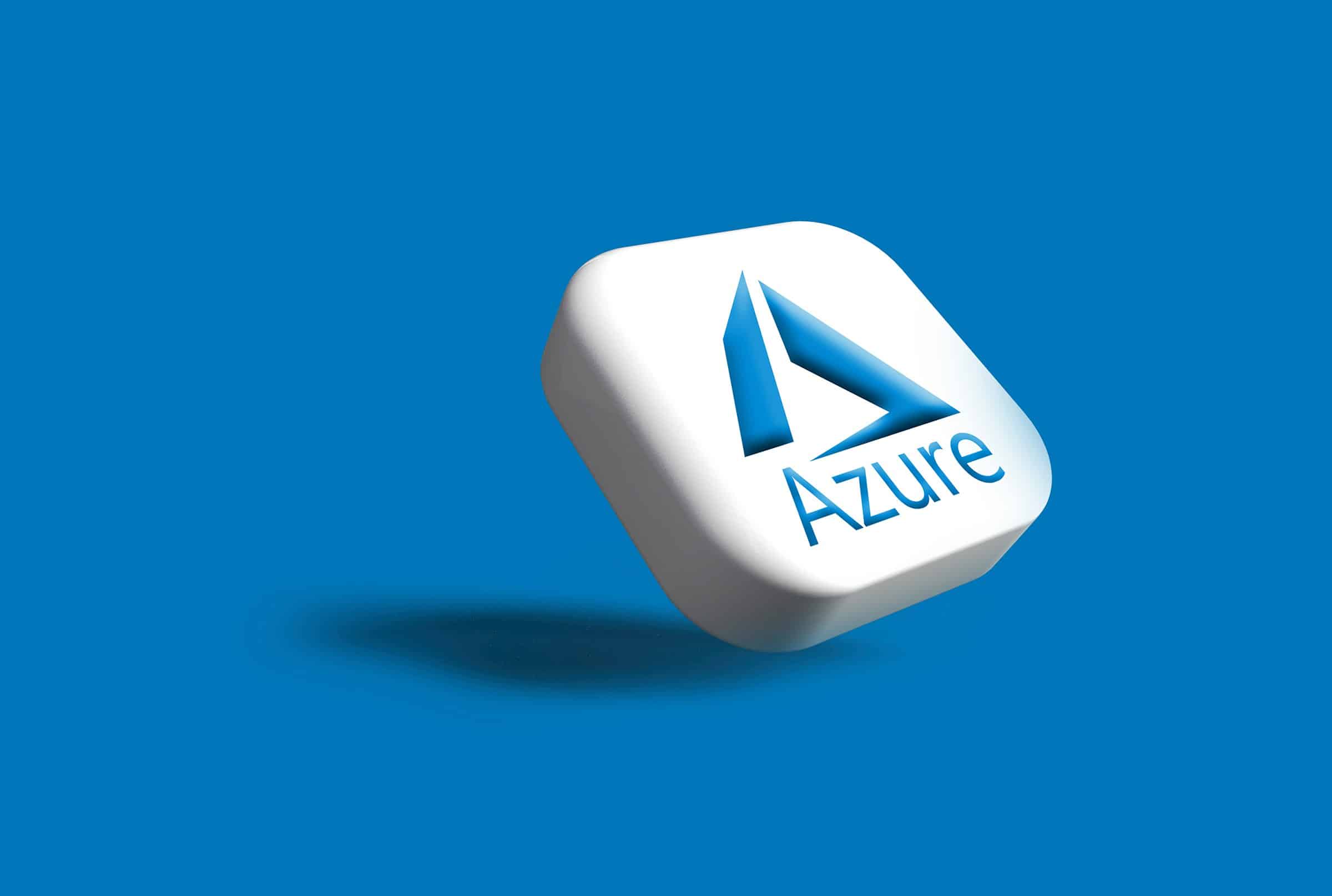 A 3D rendering of a white rounded square tile tilted at an angle, displaying the Microsoft Azure logo — a stylized blue letter "A" formed from three angled shapes above the word "Azure" in blue text — casting a soft shadow on a solid blue background.