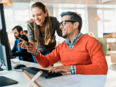 Business team reviewing Sage 100 2026 upgrade planning at computers