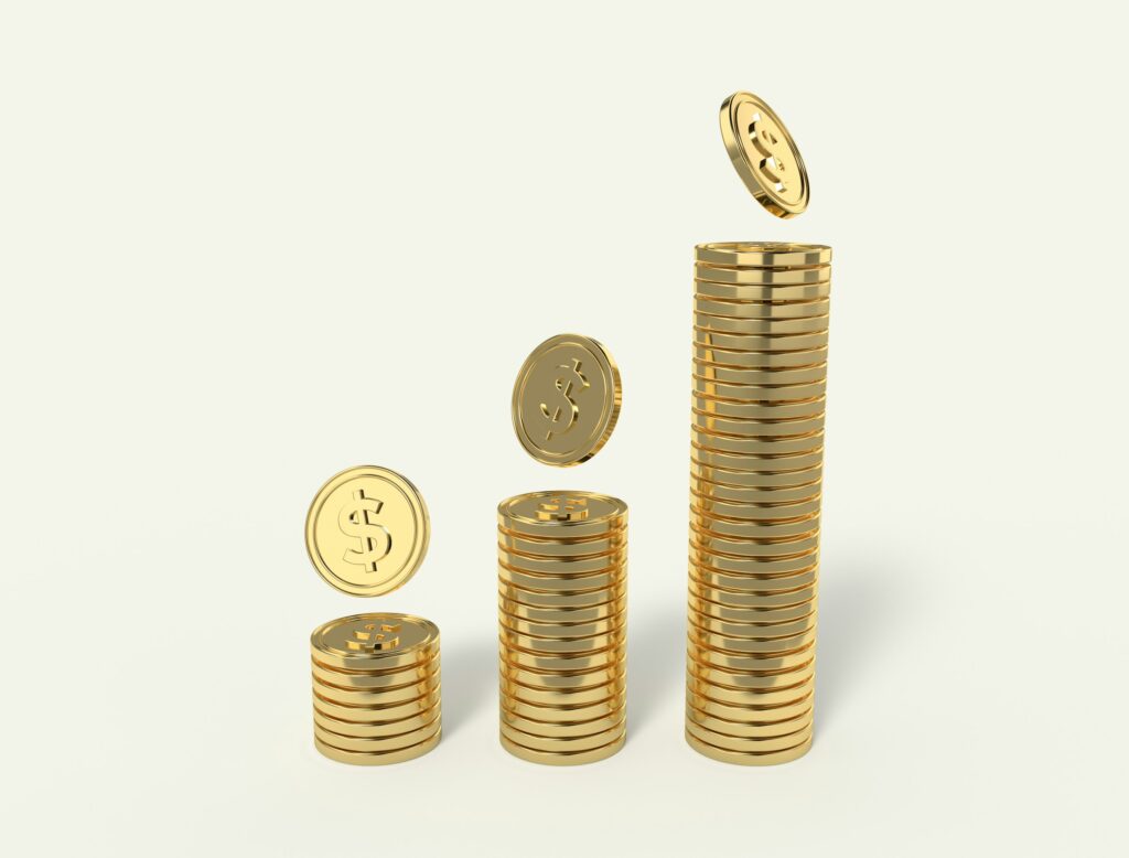Three stacks of gold dollar coins rising in height from left to right, with a coin falling toward the top of each stack against a plain off-white background
