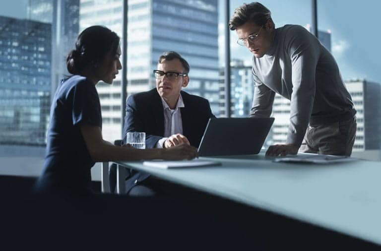 Executives reviewing real-time portfolio margin data on a digital dashboard